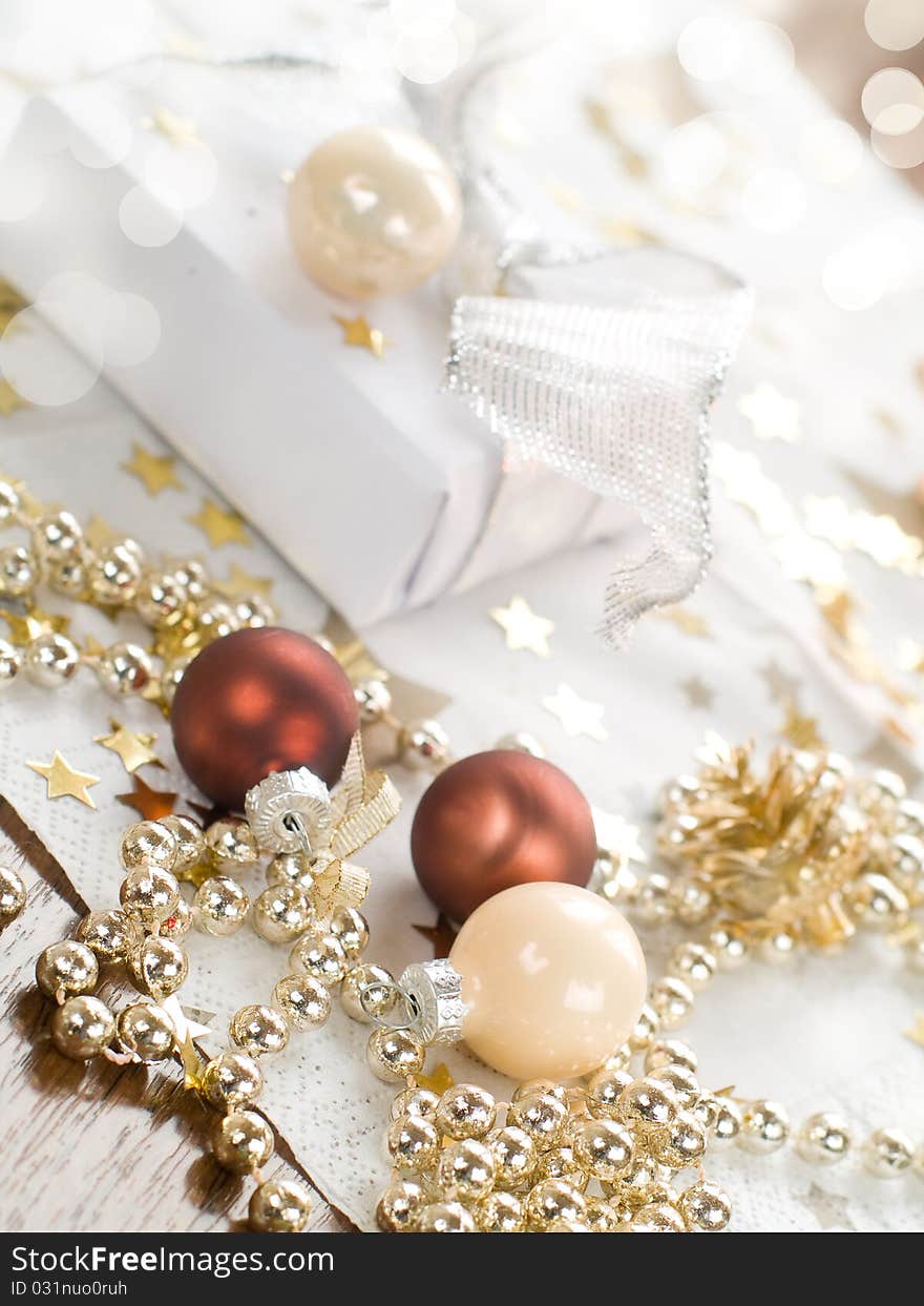 Christmas gift and baubles on defocused lights background. Christmas gift and baubles on defocused lights background