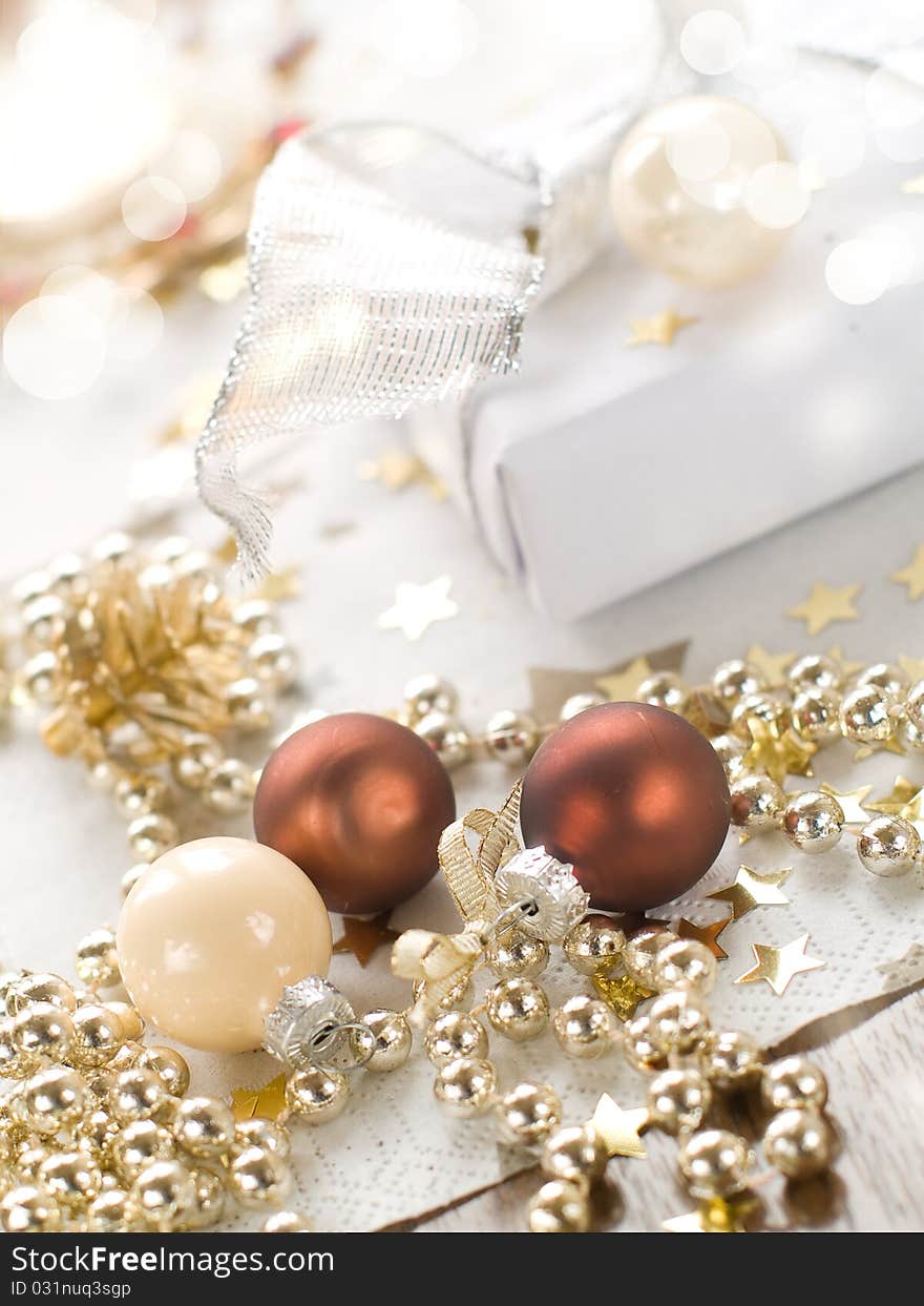 Christmas gift and baubles on defocused lights background. Christmas gift and baubles on defocused lights background