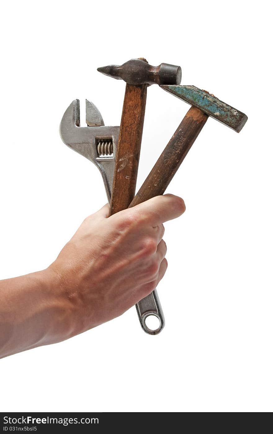 Wrench and 2 hammers in hand