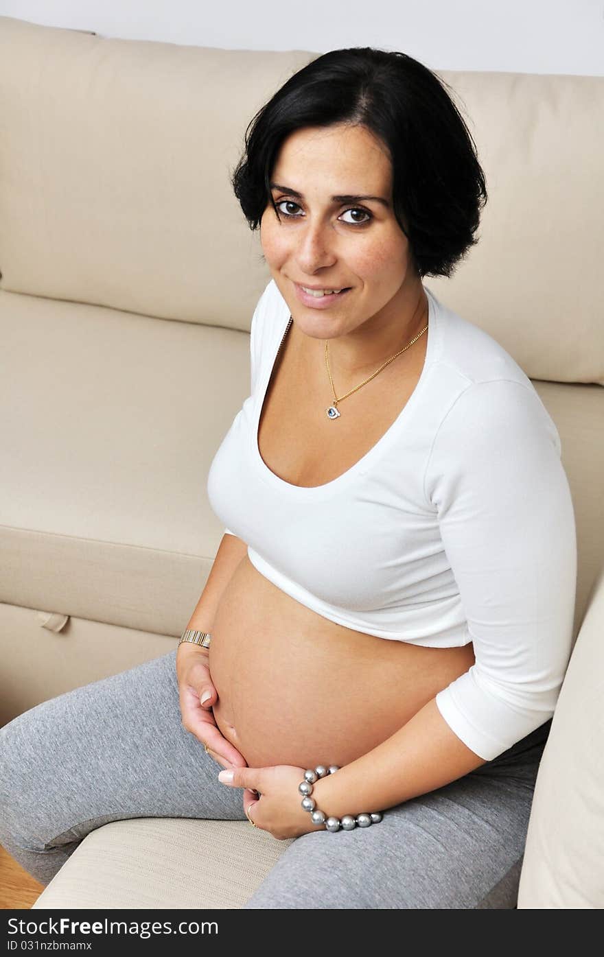 Pregnant woman sitting on sofa