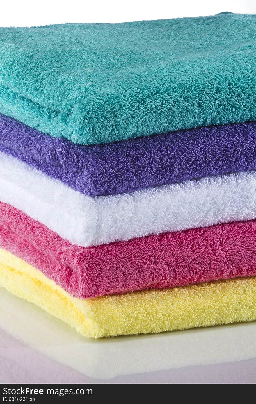 Bath towels against a white background in a studio environment. Bath towels against a white background in a studio environment