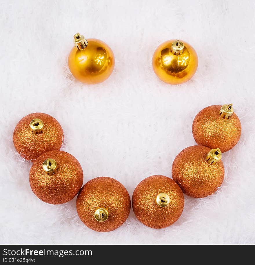 Christmas golden brightly spheres on the white fur