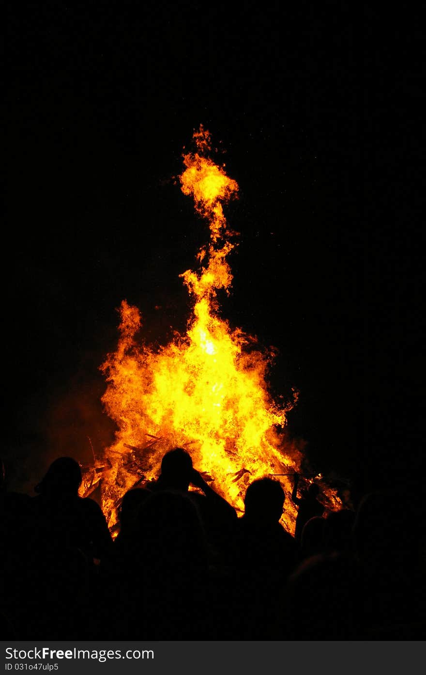 People in front of a fire during a festival