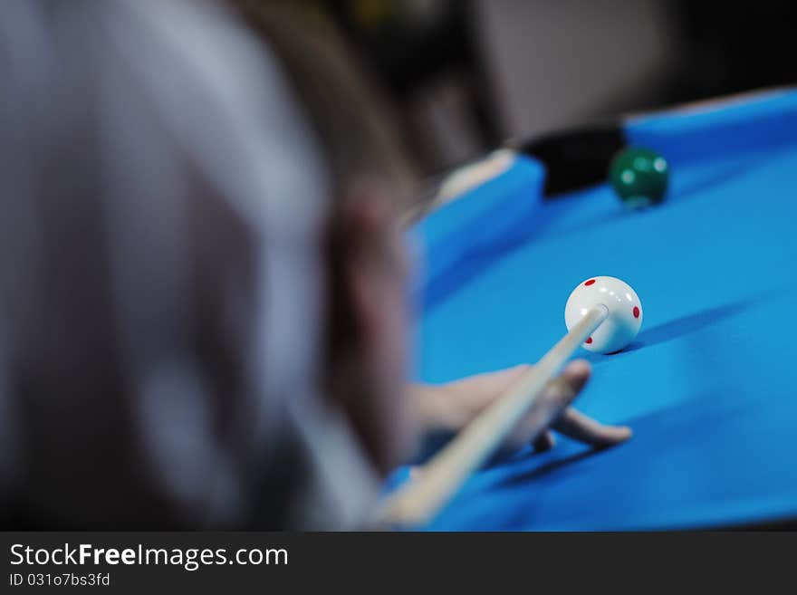 Young man play pro billiard game