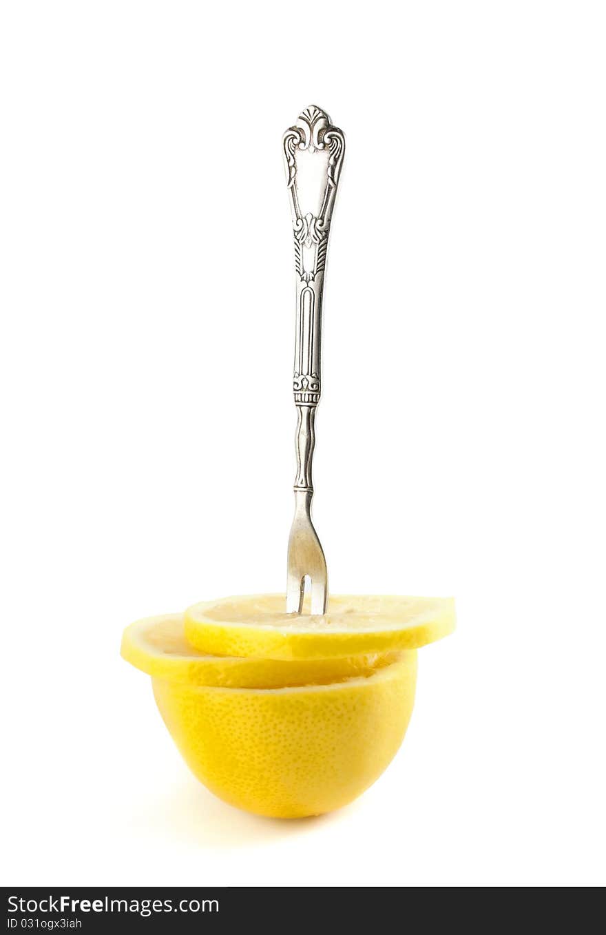 Llemon slices with a fork. Isolated on a white background