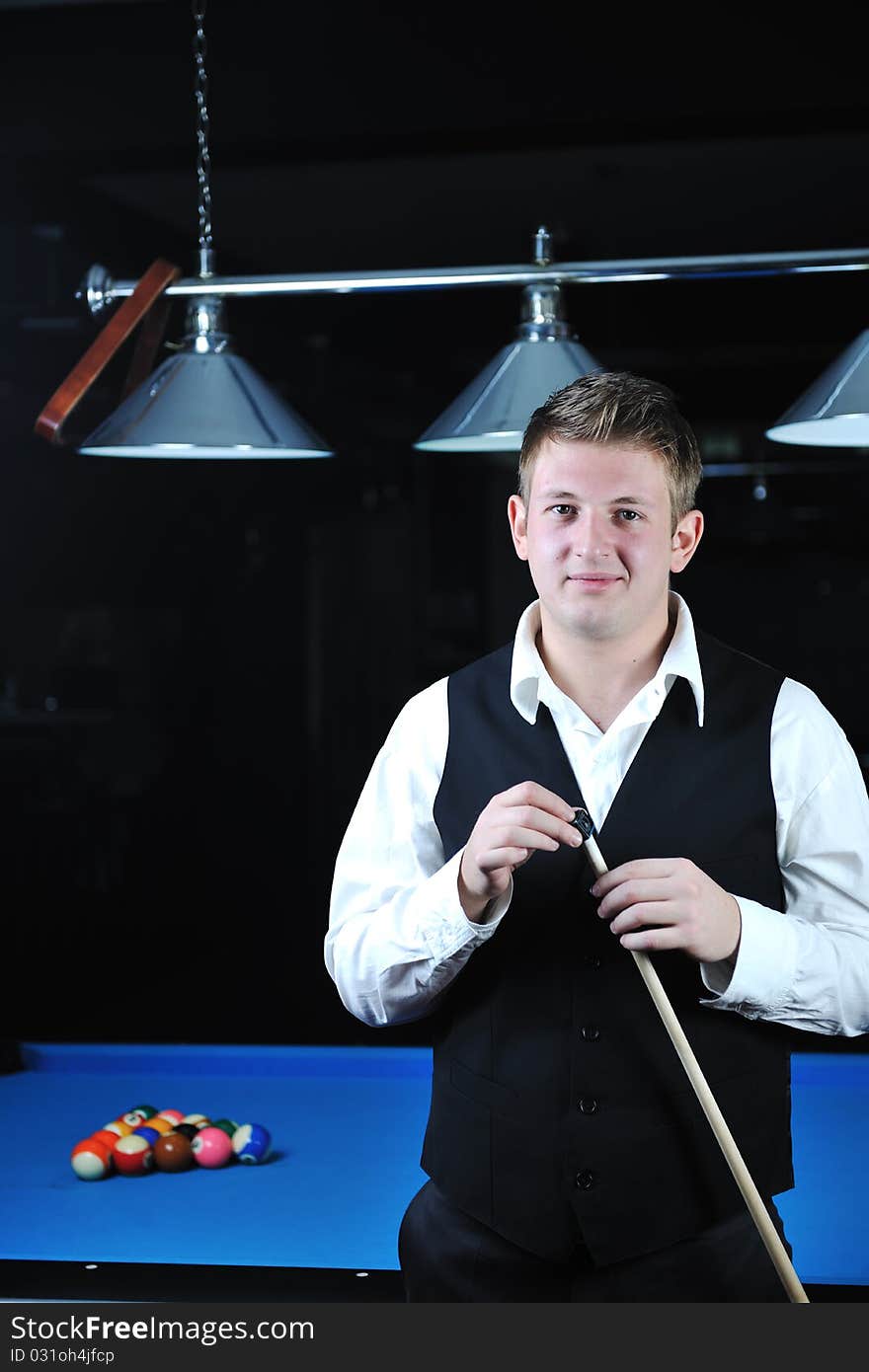 Young man play pro billiard game