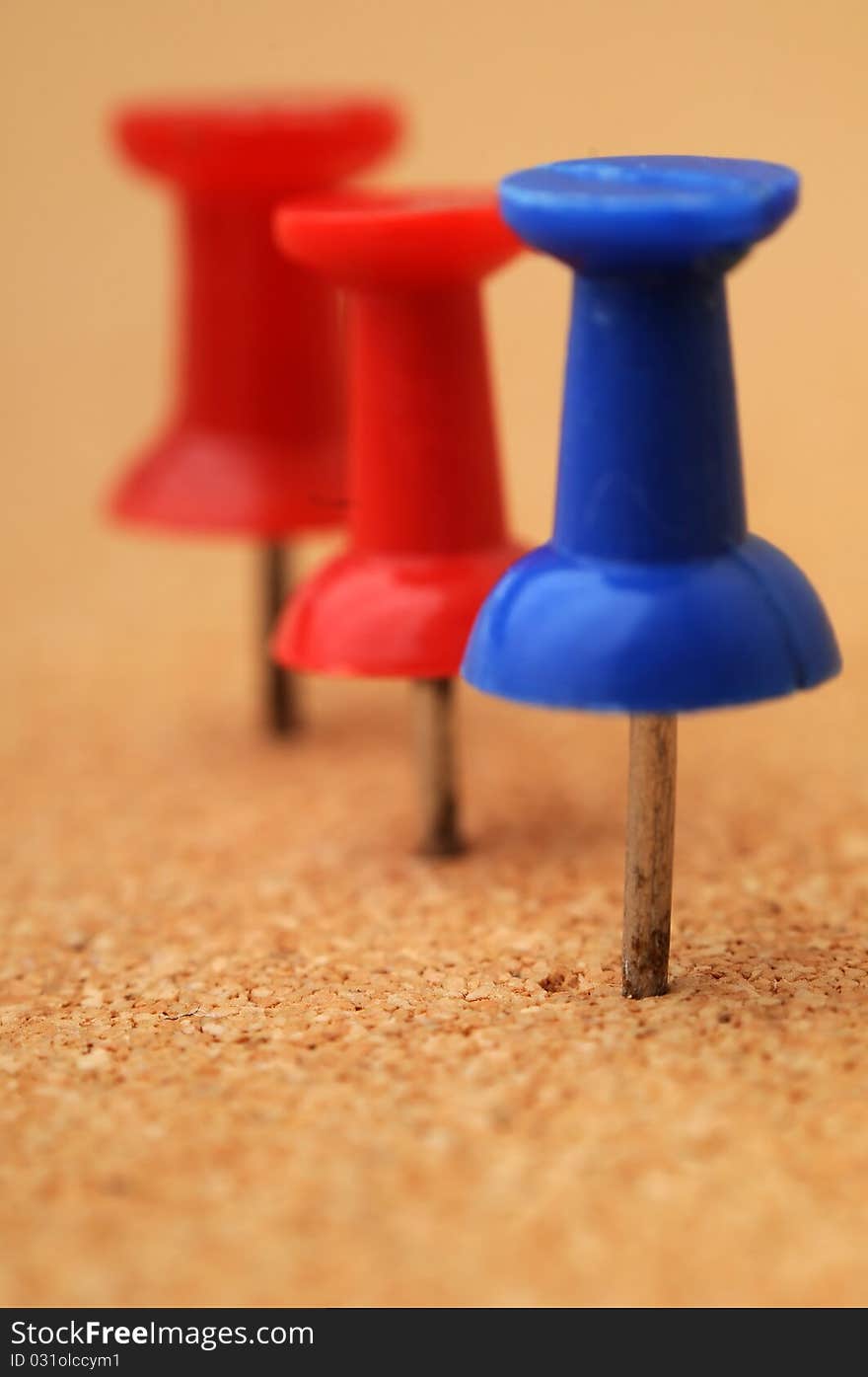 Pushpins on a corkcoard. Macro closeup with shallow depth of field. Pushpins on a corkcoard. Macro closeup with shallow depth of field.