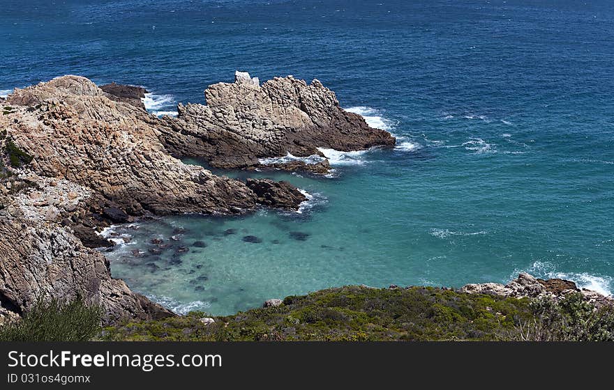 A panoramic view of an outcrop of rock and the ocean between Cape Town and Cape Hangklip on the Atlantic Ocean seaboard, South Africa. A panoramic view of an outcrop of rock and the ocean between Cape Town and Cape Hangklip on the Atlantic Ocean seaboard, South Africa