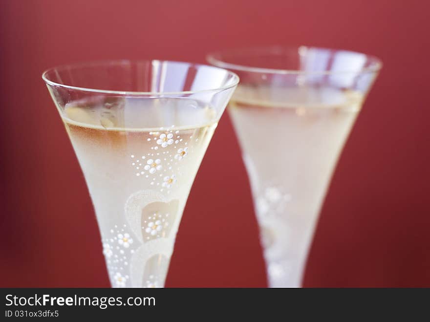 Two champagne glaases on red background