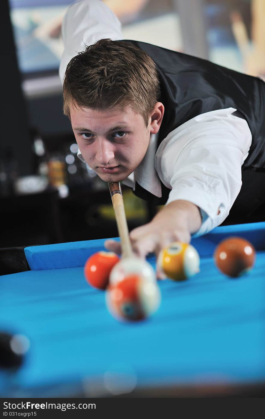 Young man play pro billiard game