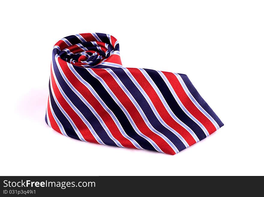 Striped Red and Blue Neck Tie rolled up into a coil. Striped Red and Blue Neck Tie rolled up into a coil.