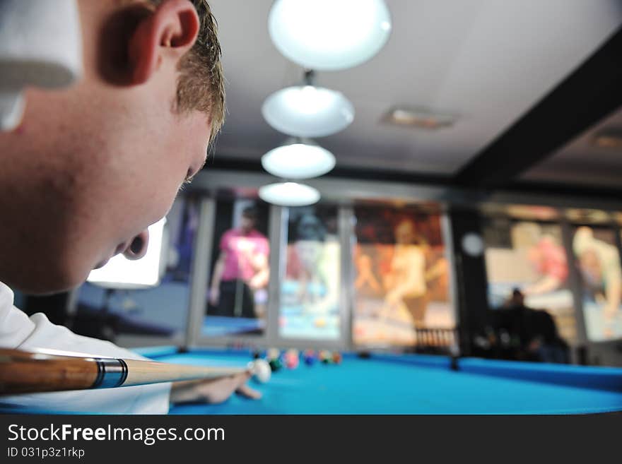 Young man play pro billiard game