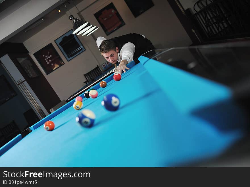 Young man play pro billiard game