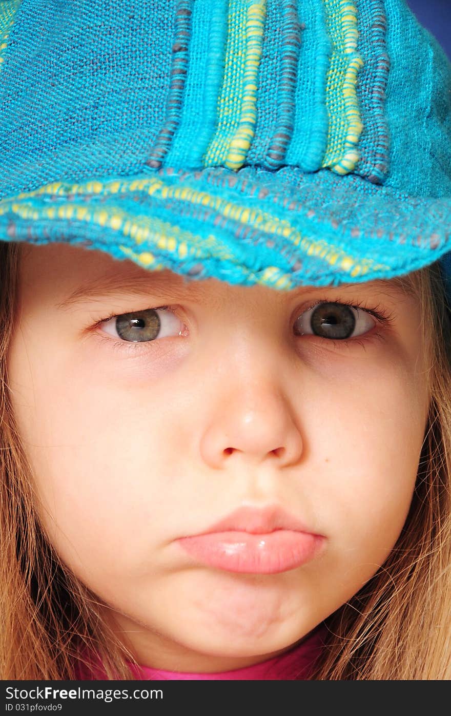 Angry girl with blue hat