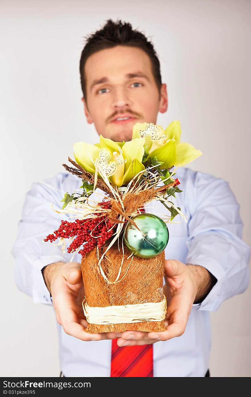 Young man in shirt and tie with a Christmas gift. Young man in shirt and tie with a Christmas gift