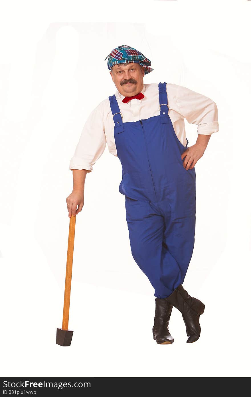 Cheerful worker in overalls with a hammer isolated. Cheerful worker in overalls with a hammer isolated