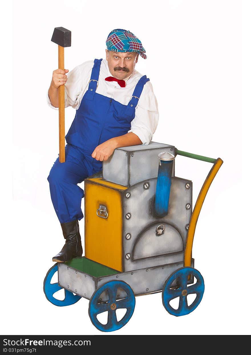 Cheerful worker in overalls with a hammer isolated. Cheerful worker in overalls with a hammer isolated