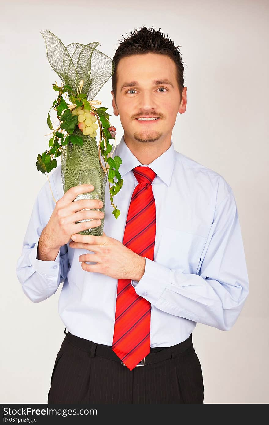 Young man in shirt and tie hold and shows gift. Young man in shirt and tie hold and shows gift.