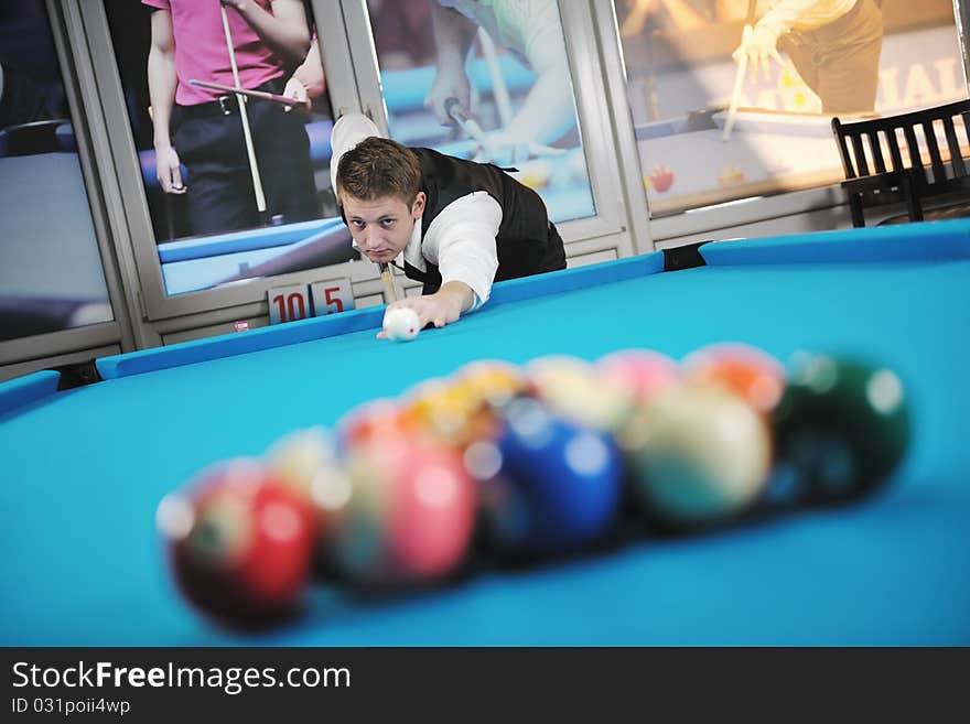 Young man play pro billiard game