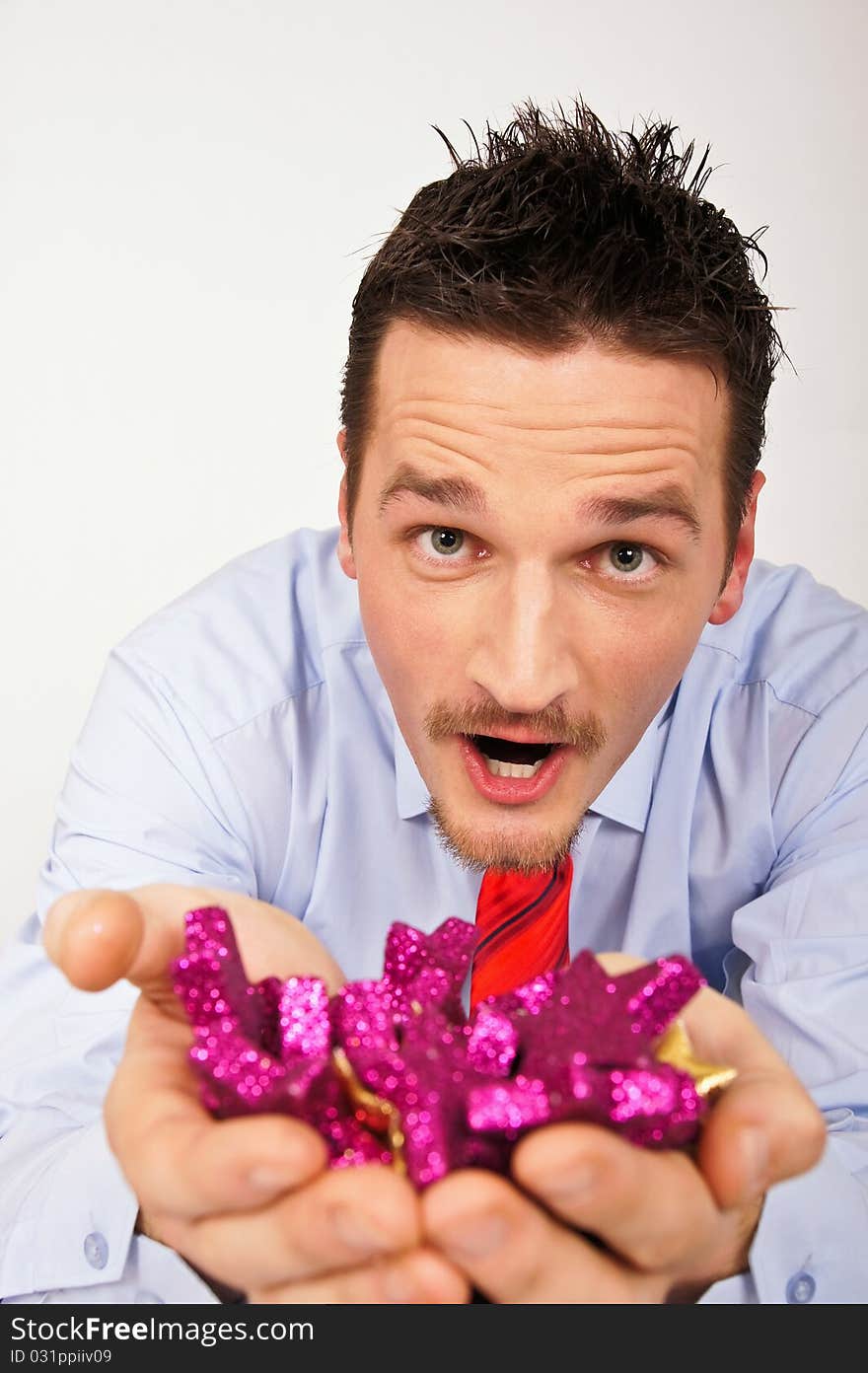 Happy young man in shirt and tie is surprised from Christmas stars. Happy young man in shirt and tie is surprised from Christmas stars.