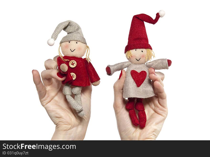 Studio photo of woman's hands playing with puppets. Pair of dwarves on the white background.