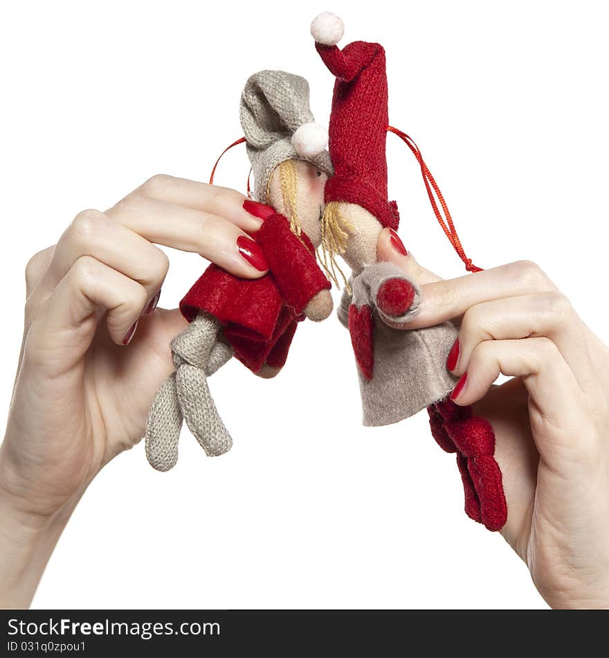 Studio photo of woman's hands playing with puppets. Pair of dwarves on the white background.