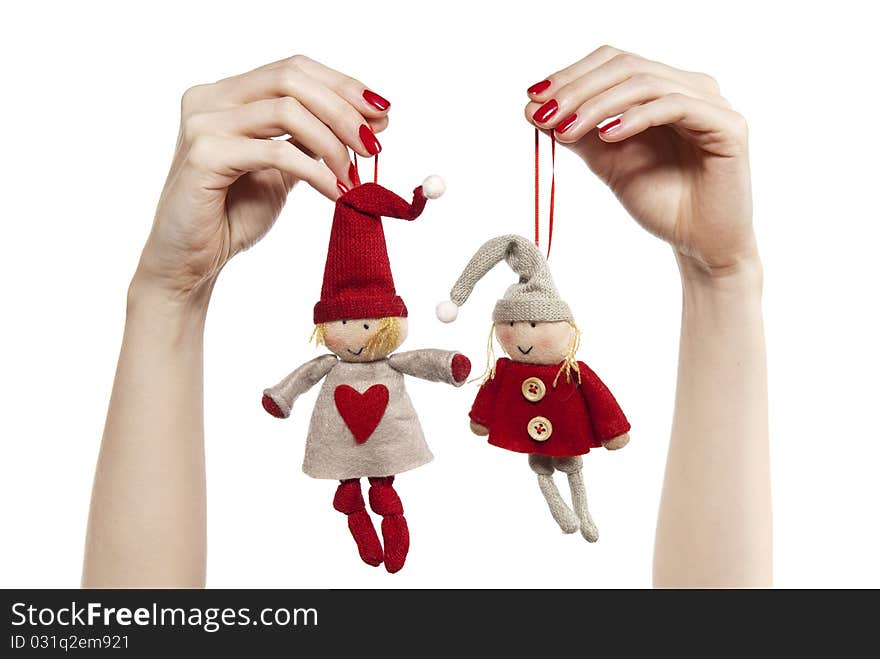 Studio photo of woman's hands playing with puppets. Pair of dwarves on the white background.