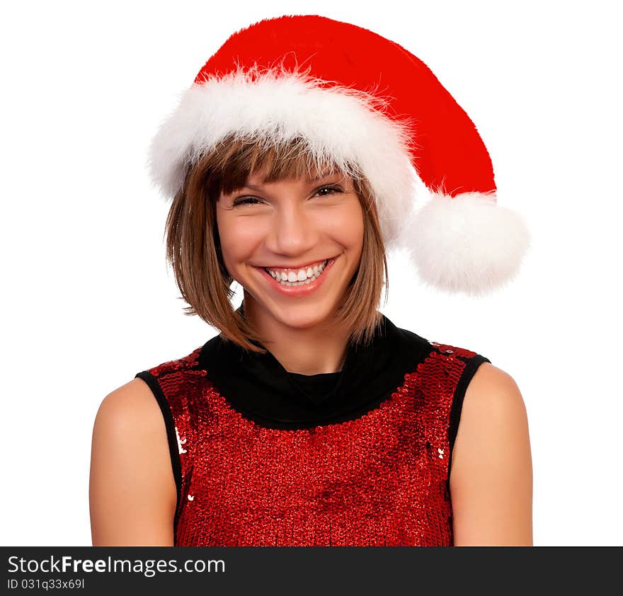 Smiling christmas girl holding gifts wearing Santa hat. Isolated on white background.