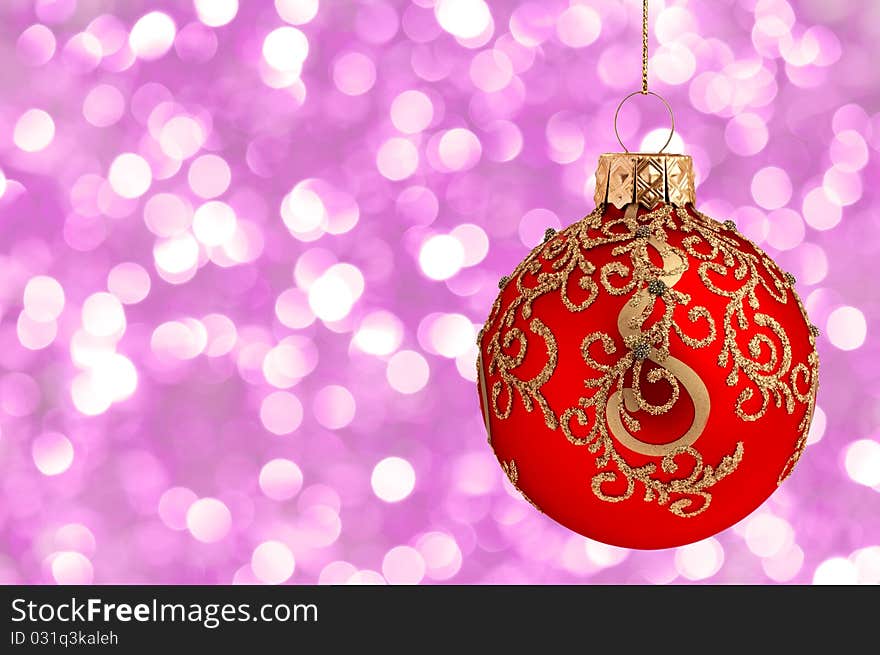 Christmas ball on abstract violet lights as background