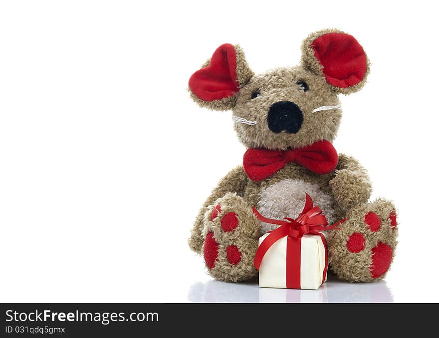 Fluffy toy mouse with a wrapped box, isolated on a white background