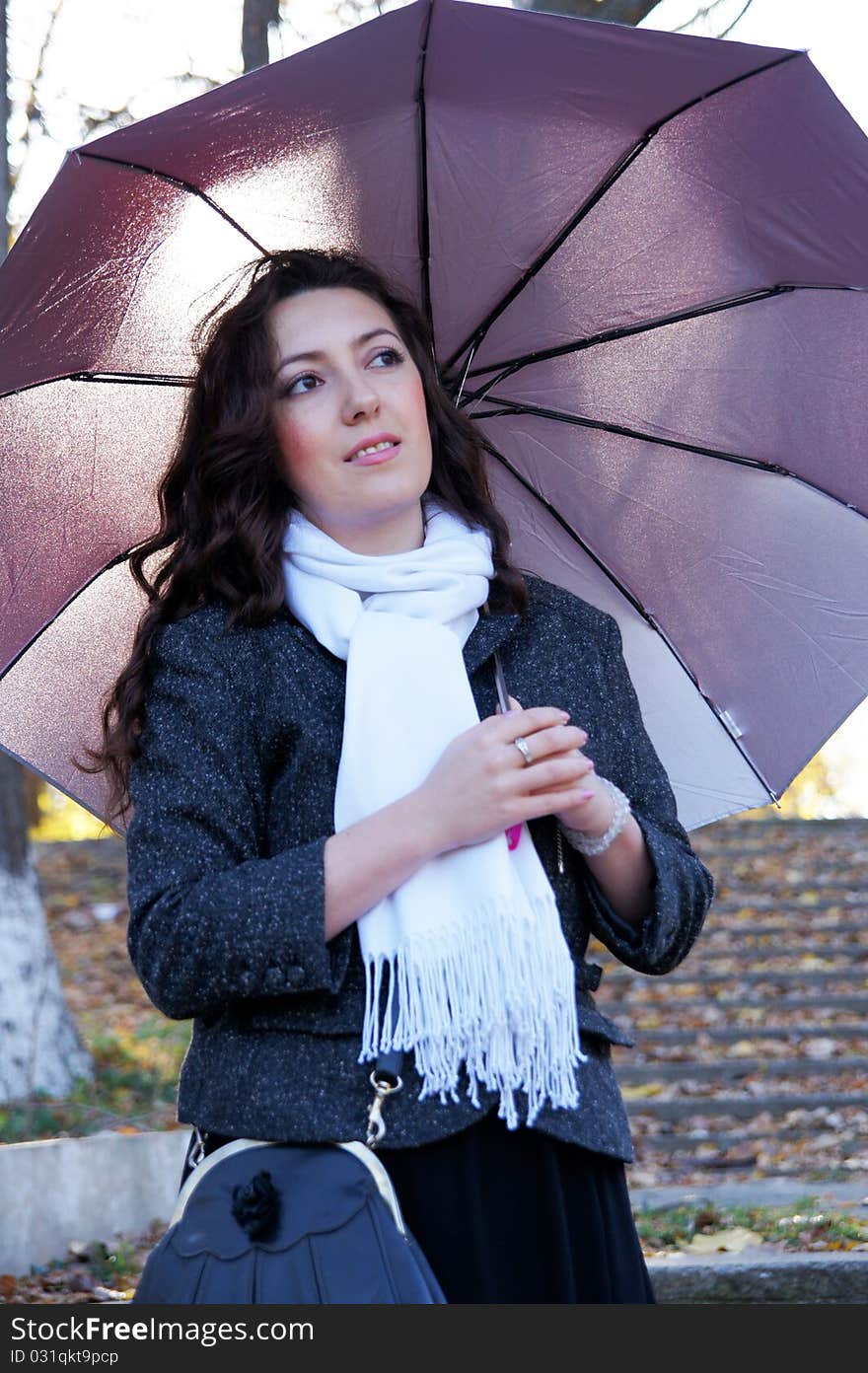 Beautiful girl with an umbrella on the steps of an abandoned ladder. Beautiful girl with an umbrella on the steps of an abandoned ladder.