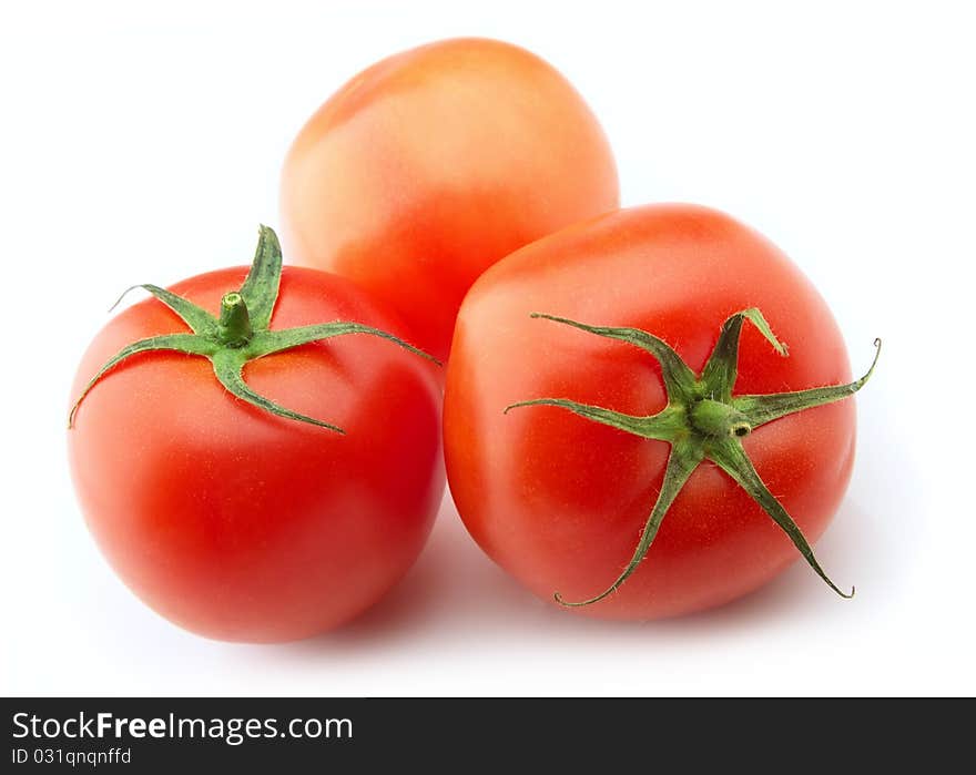 Ripe tomatoes on a white background