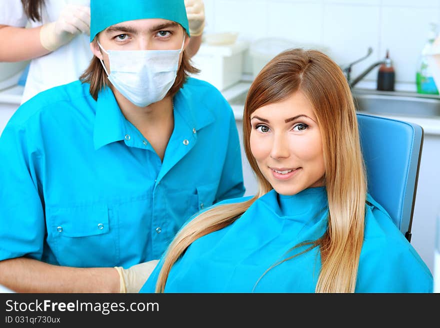 Shot of a young woman with dentist in a dental surgery. Healthcare, medicine. Shot of a young woman with dentist in a dental surgery. Healthcare, medicine.