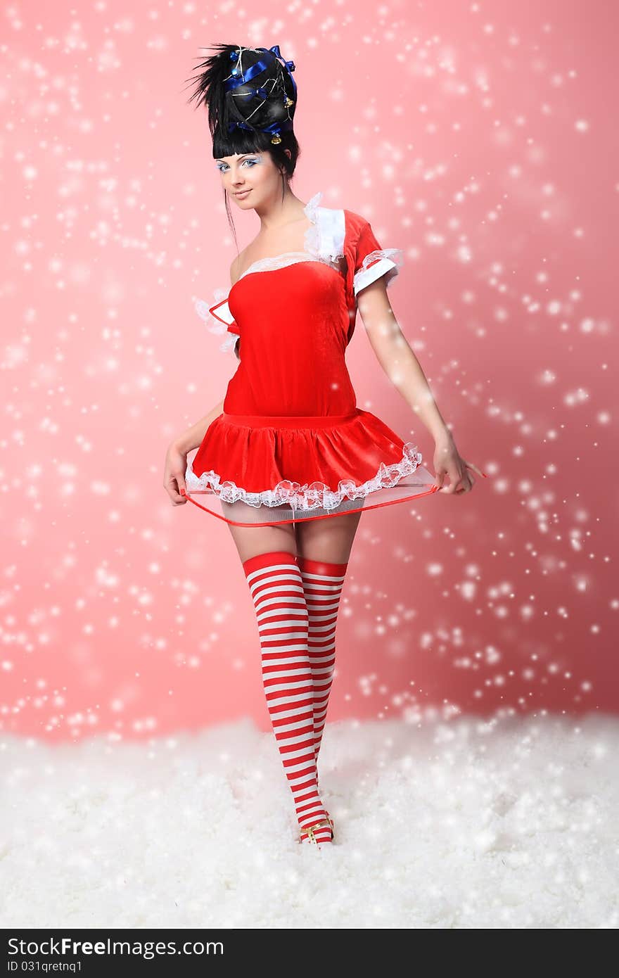 Beautiful young woman in Santa Claus clothes over pink background. Beautiful young woman in Santa Claus clothes over pink background.