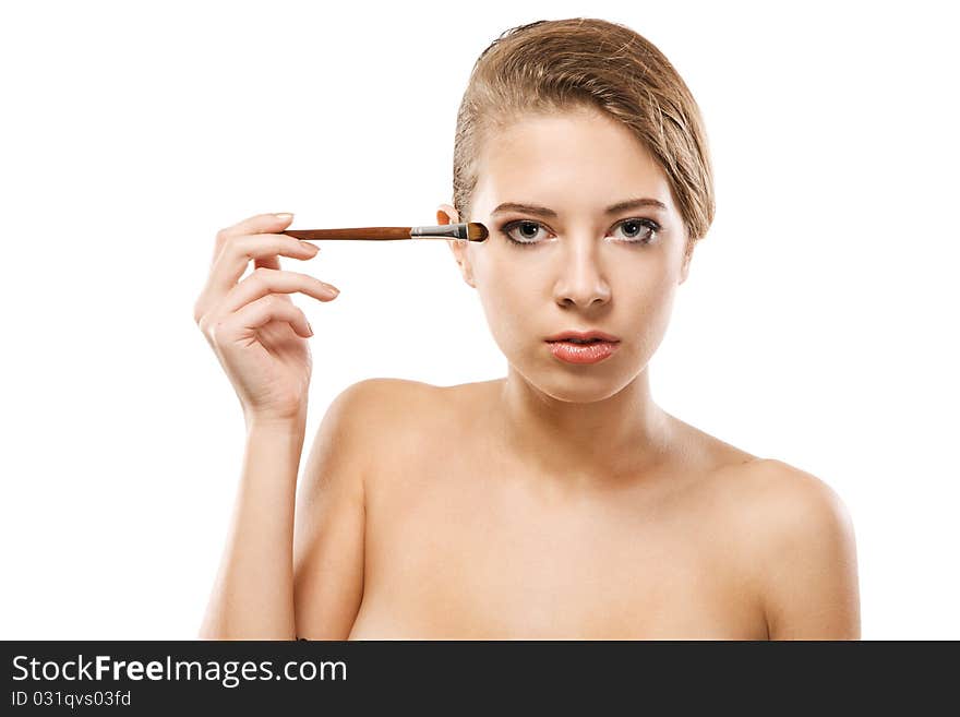 Portrait of a beautiful young woman applying makeup. Portrait of a beautiful young woman applying makeup