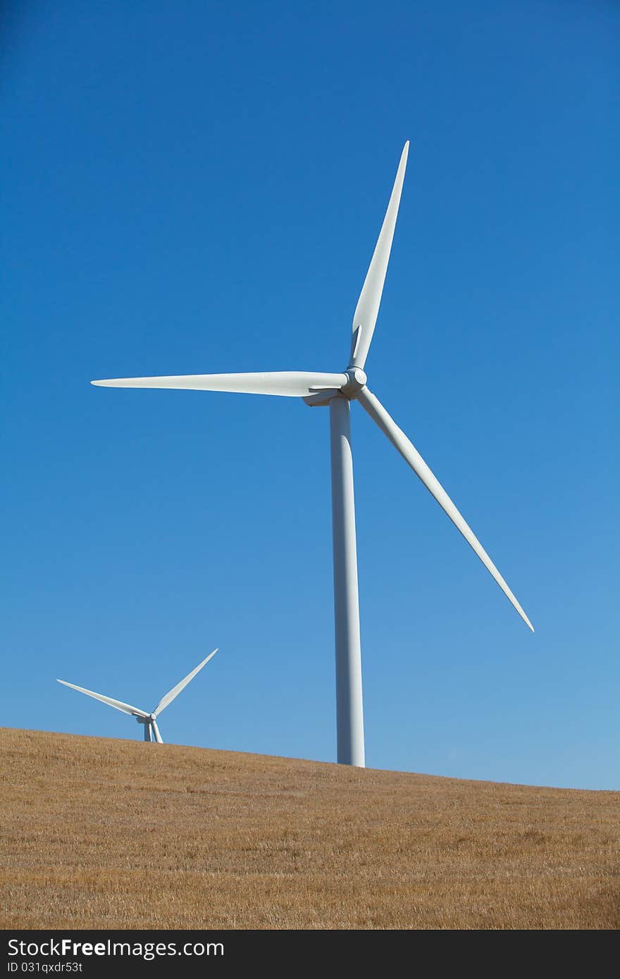 A wind farm in rolling foothills