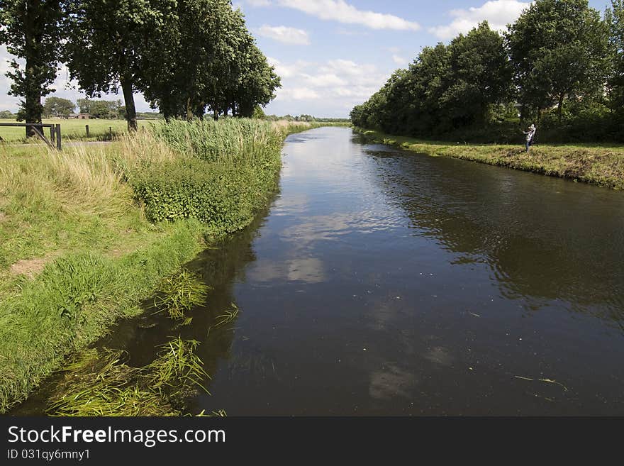 A small canal in the middle of the meadows. A small canal in the middle of the meadows