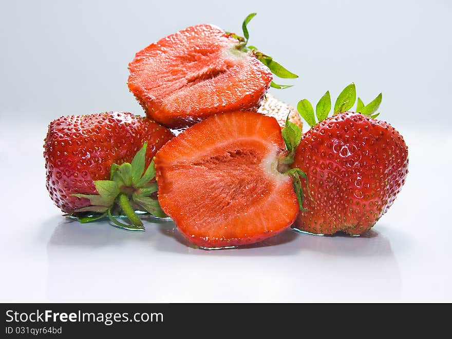 Whole strawberry and half isolated on white. Whole strawberry and half isolated on white