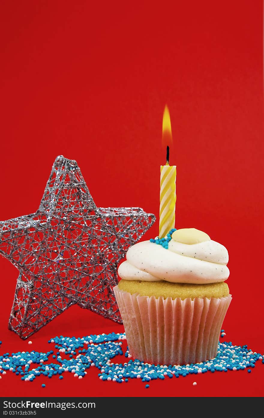 Cupcake With Candle And Star On Red Background