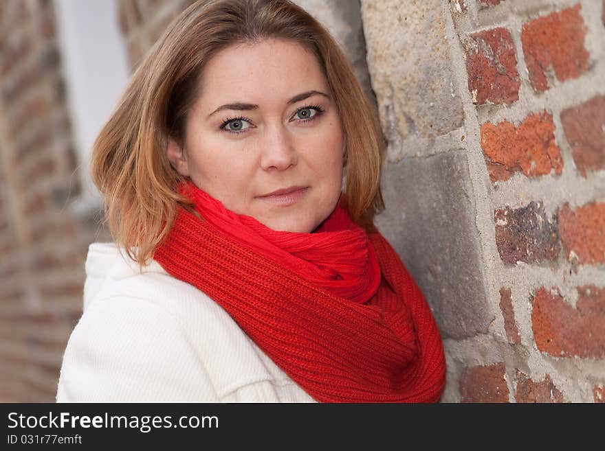 Woman standing by the wall. Woman standing by the wall