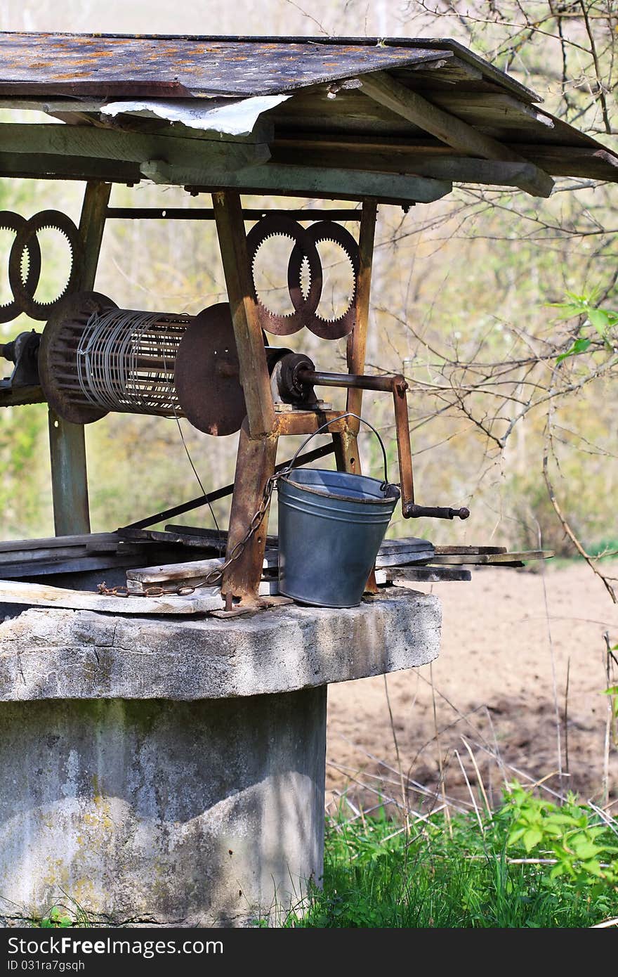 Gray stone well with rope and bucket. Gray stone well with rope and bucket