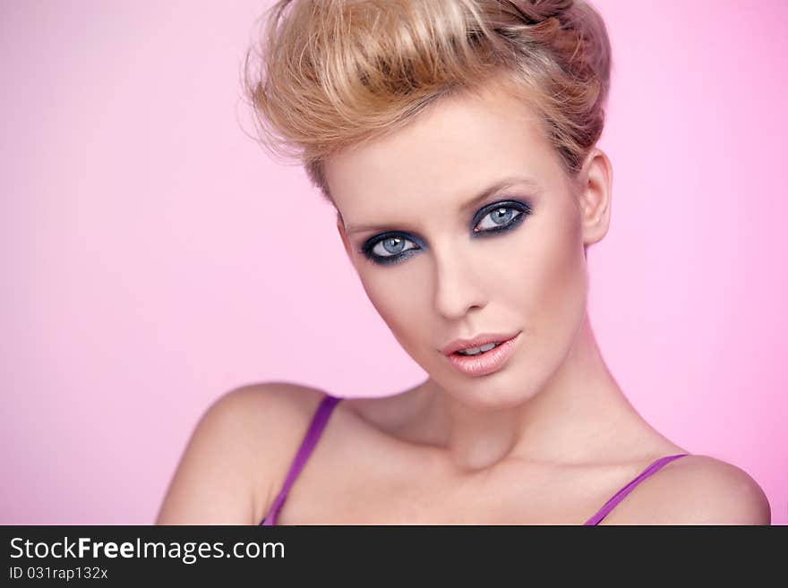 Portrait of a beautiful woman isolated on pink background