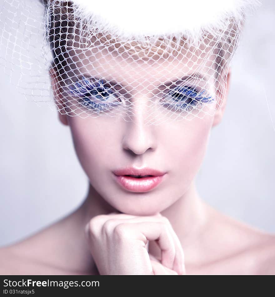 Portrait of a beautiful woman wearing a veil isolated on white