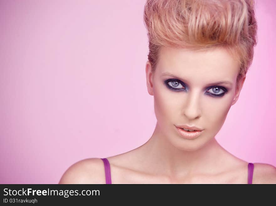 Portrait of a beautiful woman isolated on pink background