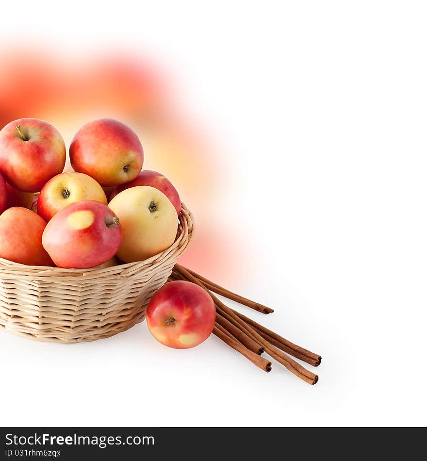 Basket with apples and cinnamon on a white background. Basket with apples and cinnamon on a white background