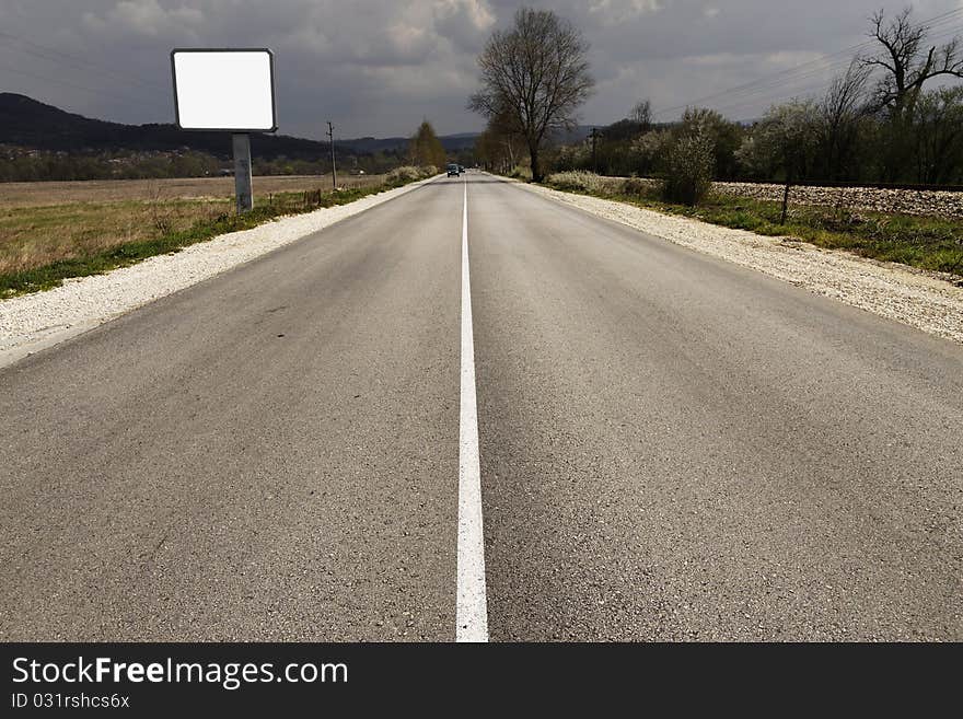 Empty Road Through Fields