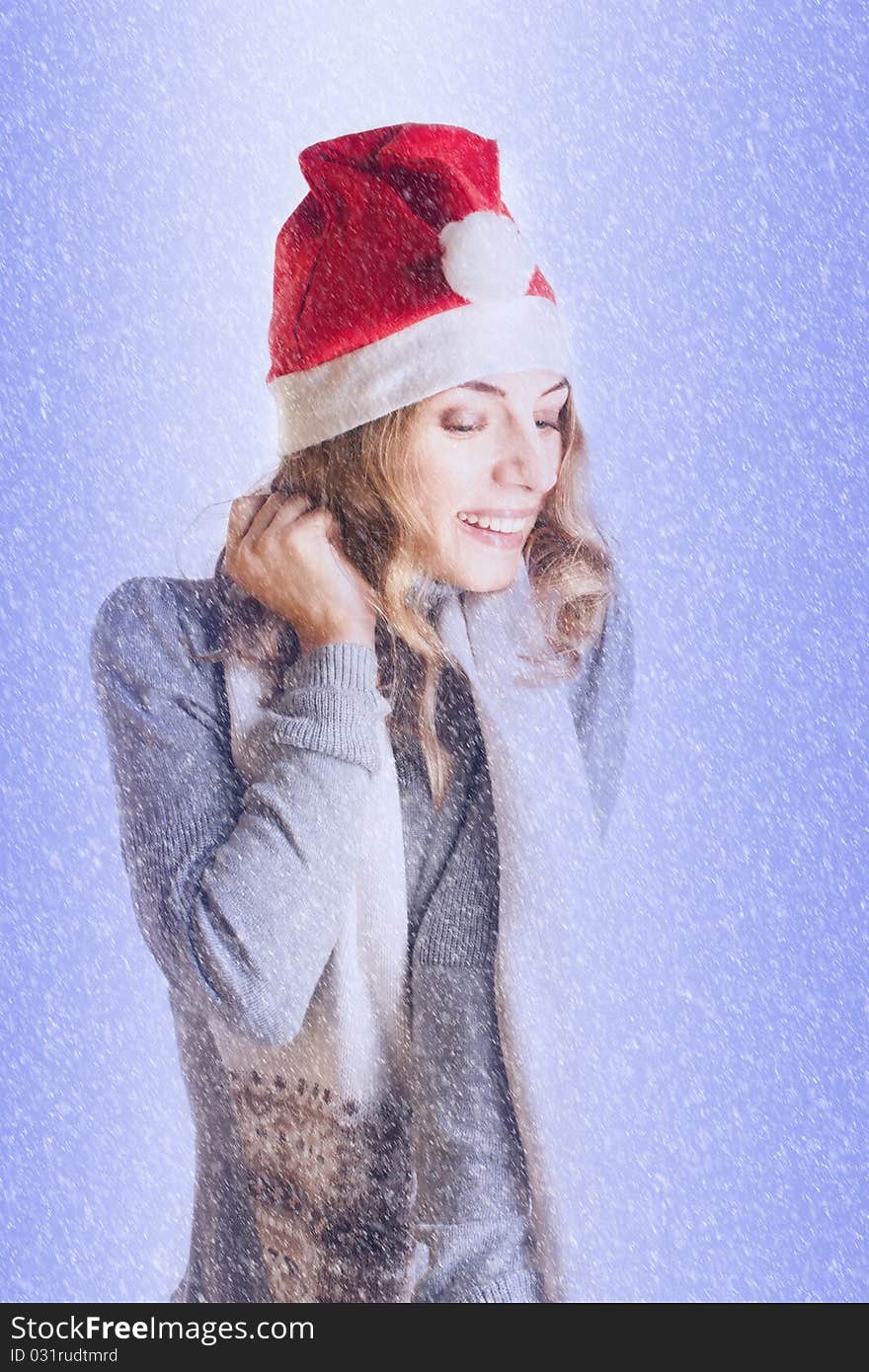 Portrait of a beautiful young woman in Santa hat in the snow (Isolated on white background)