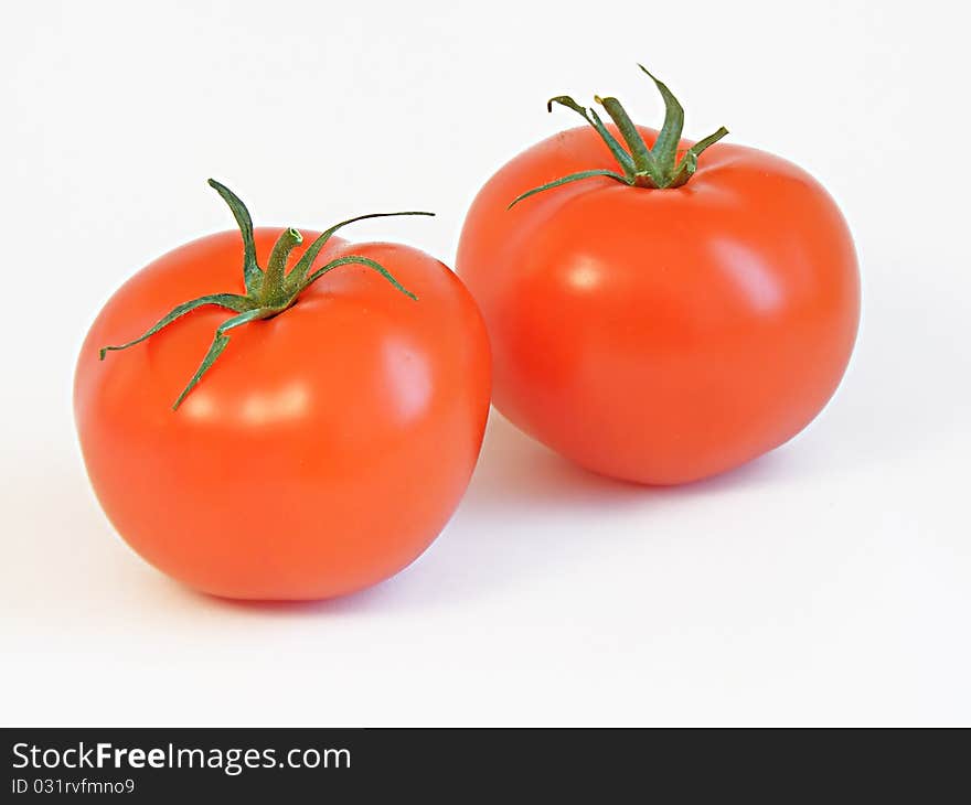 Two ripe tomatoes isolated on white background