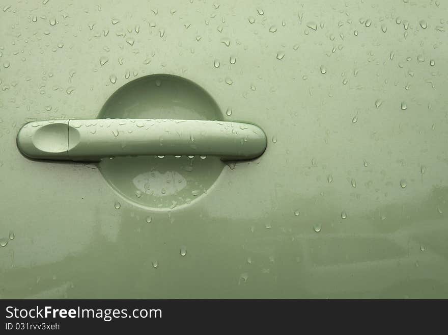 Green handle on the door of the car