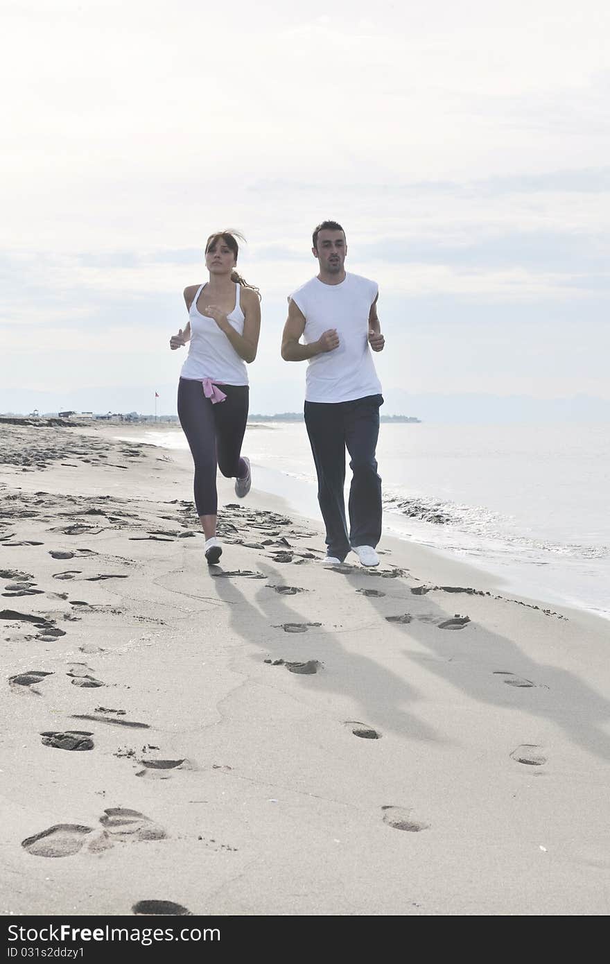 Happy young couple have fun at beautiful beach